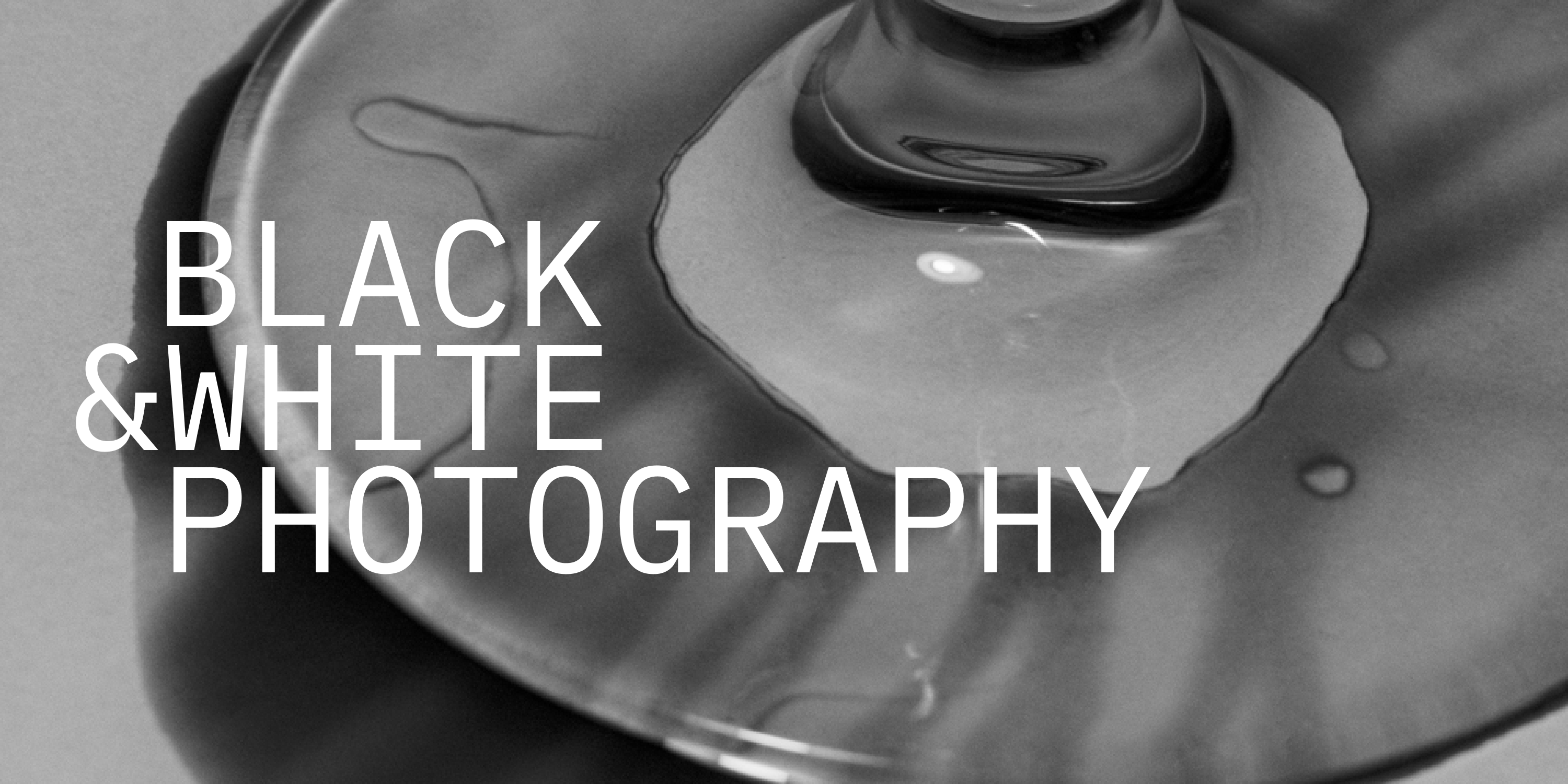 a close up shot of a martini glass, with the words Black & White Photography in front