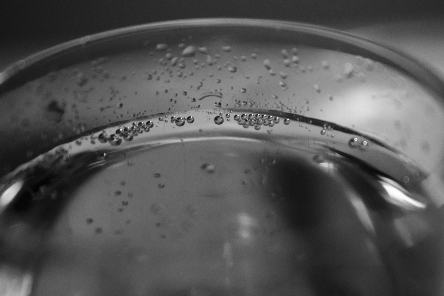 water droplets and bubbles on the side of a glass